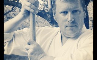 The author, holding a bokken (wooden sword).