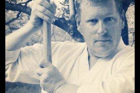 The author, holding a bokken (wooden sword).